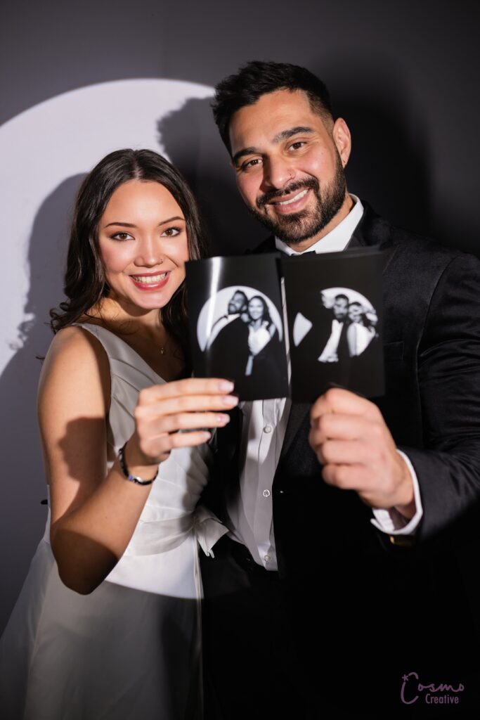 Bride and groom showing off their photos