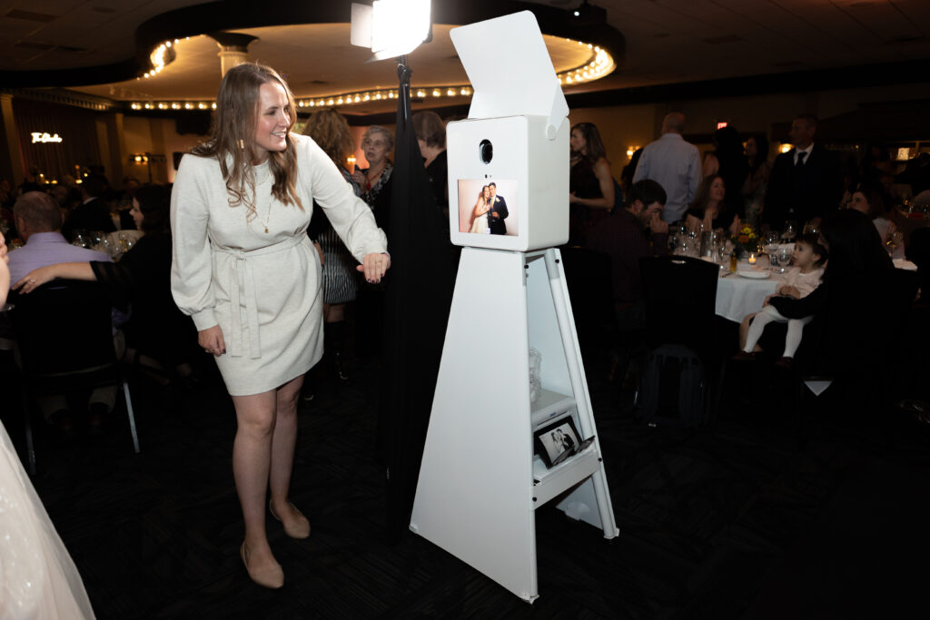 Woman looking a photo taken with a wedding photo booth