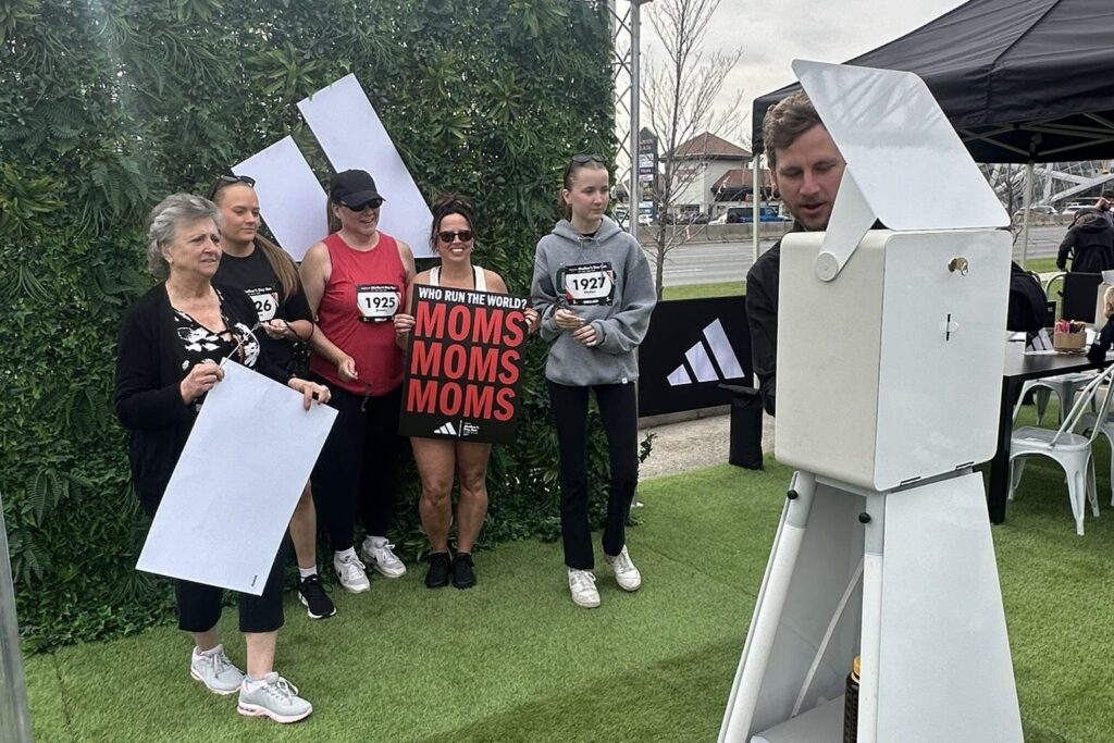 Brand activation photo booth with greenery backdrop