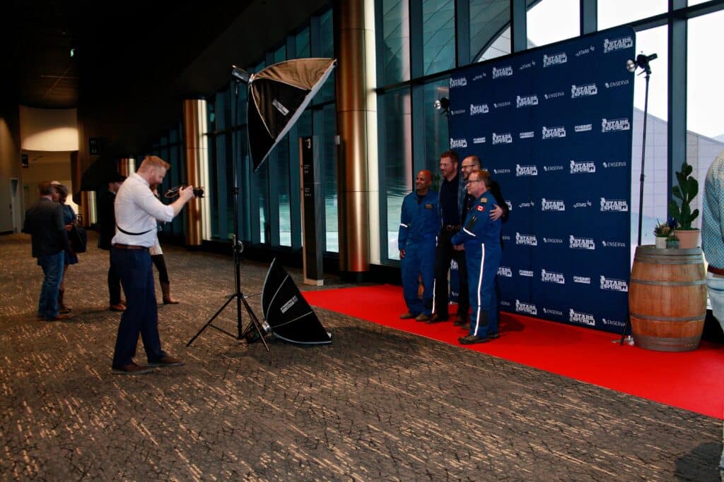 Branded photo experience at corporate event with Cosmo Photo Booths and event staff capturing images.
